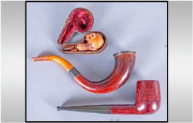 Meerschaum Cheroot Holder and Two Wood Pipes, the meerschaum carved as an eagle's talons clutching