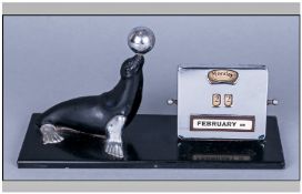 Art Deco Chrome & Metal Figural Desk Day Date Calendar in the form of a sealion. Balancing a