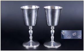 Modern Matched Pair Of Silver Goblets Of Plain Form with turned columns. Raised on circular bases.