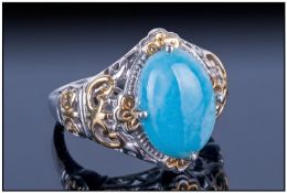 Larimar Solitaire Ring, an oval cut cabochon of the rare, slightly mottled, sea blue gemstone