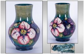 Moorcroft Balluster Shaped Vase, 'Anemone' Pattern on green ground. Stands 7" in height.