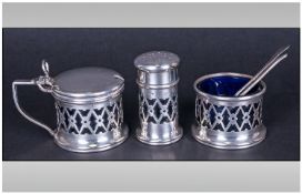 A Silver 3 Piece Cruet Set with openwork panels complete with blue liners & Hallmark for