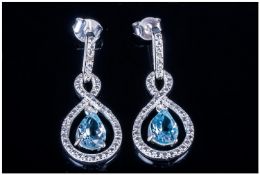 Sky Blue Topaz Infinity Drop Earrings, pear shaped blue topaz of 2.4cts suspended within '