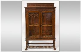 Oak Display Cabinet with Carved Gallery and  Glazed Front. Two Door Centre Opening with Barley Twist