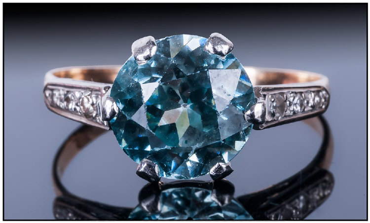10ct Gold Set Natural Blue Zircon Single Stone Ring, with diamond shoulders. The Blue Zircon of