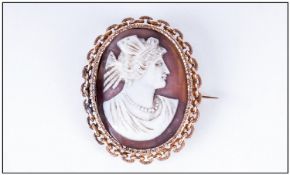 Cameo Brooch, classical maiden facing right. Fancy yellow metal mount with picture compartment to