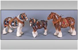 A Good Pair Of Pottery Large Shire Horses. Complete with harness and head gear. Each stands 11