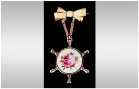 Gold & Silver Gilt Yellow Enamel Pendant/Brooch in the form of a ships wheel held by a bow tie. 2.5"