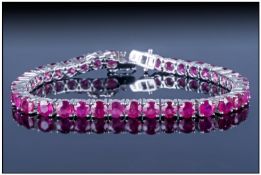 Ruby Tennis Bracelet, 25cts of round cut, rich red rubies set in a continuous line and fastened with