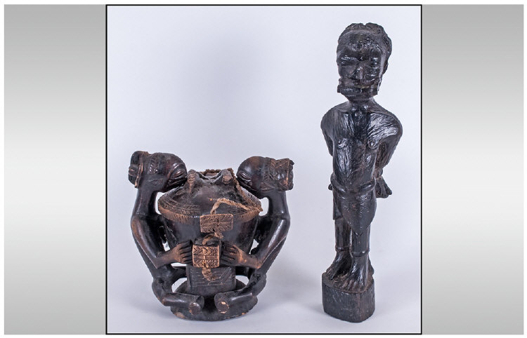 Two African Carved Figures one depicting a native in chains 15 inches high, the other a double