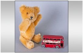 A Small Teddy, prob by Schuco, with moveable limbs, Height 6 Inches, with a Lesney Red London Bus.