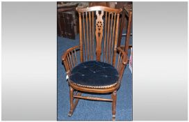 Wooden Framed Rocking Chair With Wicker Seat. Blue Velvet Detachable Cushion and Spindle Back.