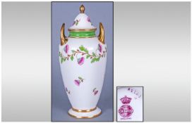 Mintons Two Handle Lidded Vase, Circa 1890. Flowers on a white ground with gold handles & borders.