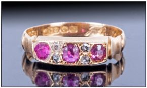 18ct Gold Gem Set Ring set with three ruby coloured stones between four diamond spacers, fully