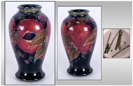 William Moorcroft Signed Small Vase, 'Pomegranate' design. Circa 1920's. Stands 4" in height.