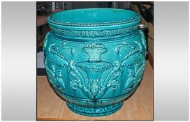 A Wardle Art Pottery Jardiniere, turquoise colour with heavy embossed floral decoration. Stamped