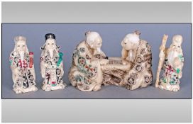 Set Of Four Matching Oriental Figures Comprising a figure group of two men playing a board game,