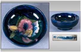 Moorcroft Pin Dish, Orchids design on blue ground. 3" in diameter.