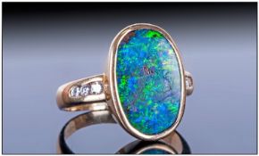 18ct Gold Single Stone Oval Shaped Black Opal Set Ring with Diamond shoulders. The black opal is top