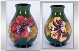 Moorcroft Global Shaped Vase 'Hibiscus' Design on green ground. 5.25" in height.