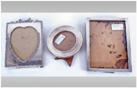 Three Various Silver Photograph Frames, an Edwardian rectangular frame with a heart shaped aperture,