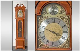 A Reproduction Brass Arch Dial Grandfather Clock, in a mahogany case, with a scroll pediment top