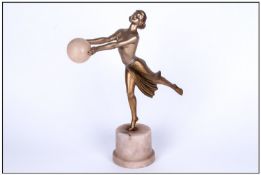 Art Deco Cold Painted Spelter Figure, Of a dancing girl with arms outstretched holding a large
