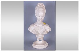 Plaster Bust Of A Young Girl with french hair style on a round pedestal base.