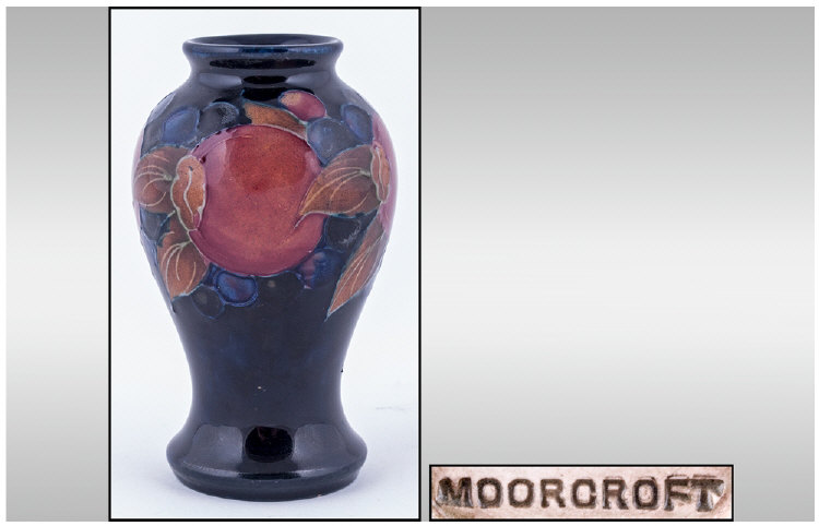 Moorcroft Small Baluster Shaped Vase. Pomegranate design on blue ground. Height 4 inches.