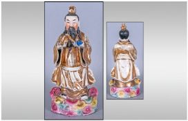 Antique Chinese Famile Rose Figurine Of A Sage Holding A Ruyha, decorated in tradition famile