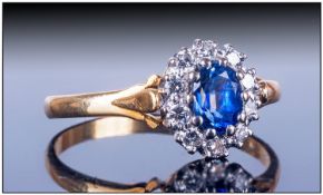 Ladies 18ct Gold Cluster Ring, Set with central oval sapphire surrounded by 10 small round cut