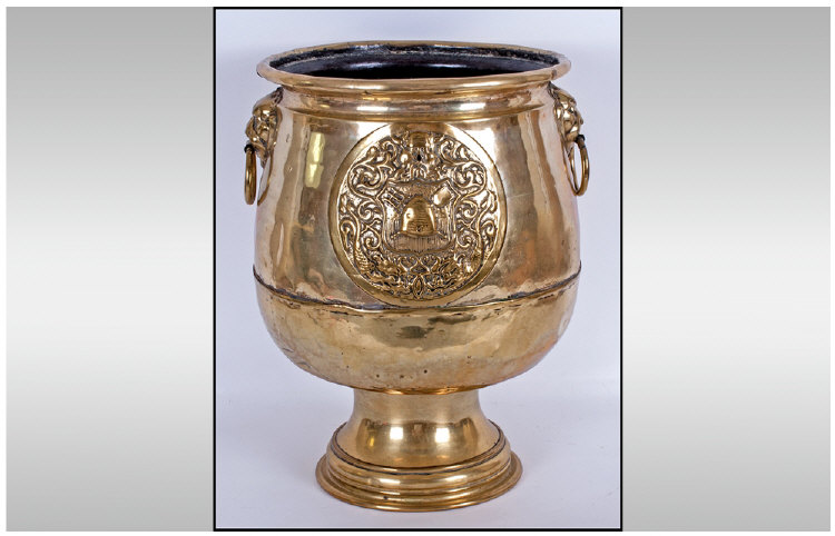 Dutch Brass Footed Planter Of Unusual Form, with brass embossed lion ring handles to the sides, the