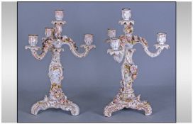 Pair of Plaue Three Branch Candelabra on rococo tripod feet, each with applied pastel flowers on a