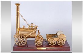A Brass Model Of Stephensons Rocket, Raised on a rectangle mahogany plinth. Realistically modelled.