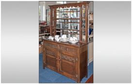 A Reproduction Oak Dresser & Rack with a 2 cupboard base and an open back plate rack.