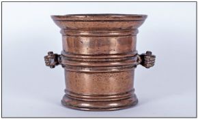 Bronze Antique Mortar with side carrying handles, in the form of clenched hands with a ribbed body.