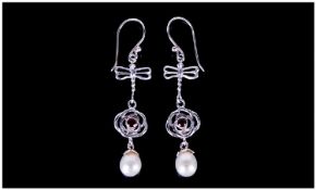 White Fresh Water Pearl and Garnet Long Drop Earrings, the pear drop shape pearls hang below hand