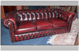 Burgundy leather Three Seater Button Back Chesterfield Sofa. As new condition.