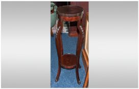 A Mahogany Edwardian Plant Pot Pedestal on carved cabriole shaped legs, with a tray top shelved