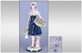Royal Dux Figure, Young woman carrying baskets of flowers, circa 1950`s. Stands 10.25 inches high,
