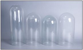 Four Victorian Glass Domes. Suitable for bisque figures and narrow clocks. Each 36cm in height.