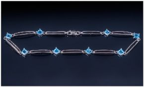 Ladies 9ct White Gold Bracelet, set with princess cut blue topaz stones. Fully hallmarked. Length