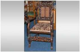 A 1920/1930`s Carved Walnut Cane Back Arm Chair, in the Willliam and Mary style.  The top bar