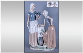 Nao by Lladro Large Figure Group `Two Ladies Drawing Water`. 16 inches in height.