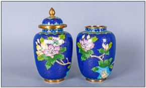 Pair of Small Cloisonne Vases, pink and yellow flowers on a French blue ground, one with cover; 4