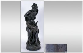 A Large Bronzed Figure Of A Semi Clad Maiden Holding A Dove sitting on a rocky out crop of fine