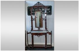 A Victorian Marble Topped Mahogany Hall Tree, with a shaped fretted scroll top, with a central