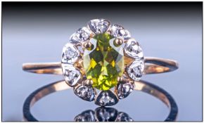 Ladies 9ct Gold Cluster Ring, Set with a central oval shaped peridot surrounded by a row of 10