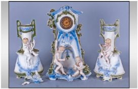 Three Piece Bisque German Clock Set 13 inches in height supported by two cherubs with a pair of