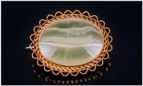 Late 19th/20th Century Brooch, Set with a pale green banded agate in a yellow metal rope twist